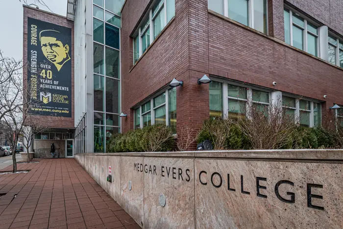 A brick building with the words "Medgar Evers College" etched on the wall
